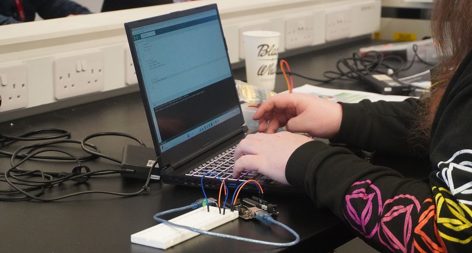 Close up of laptop and person using it