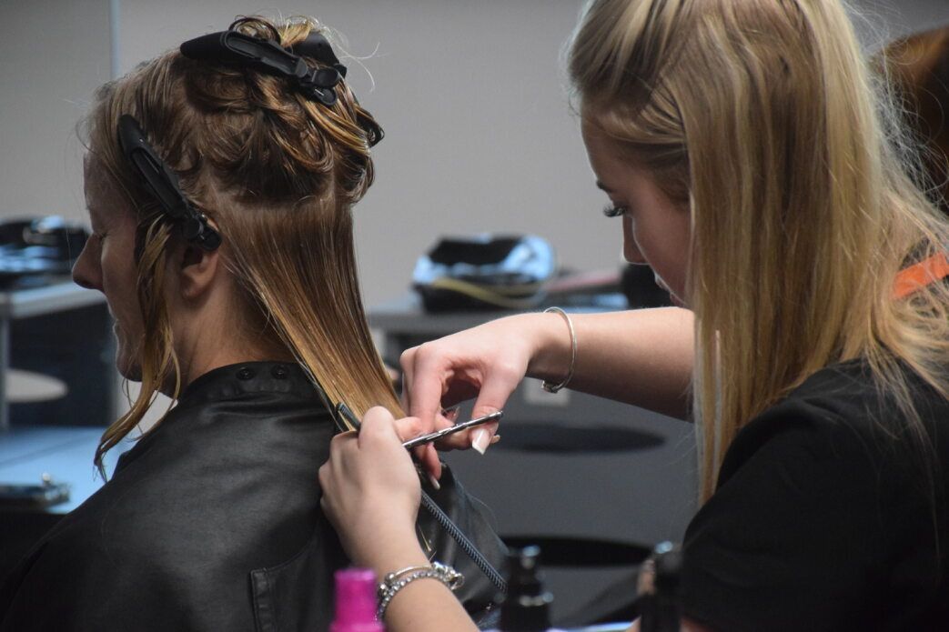 Student cutting hair